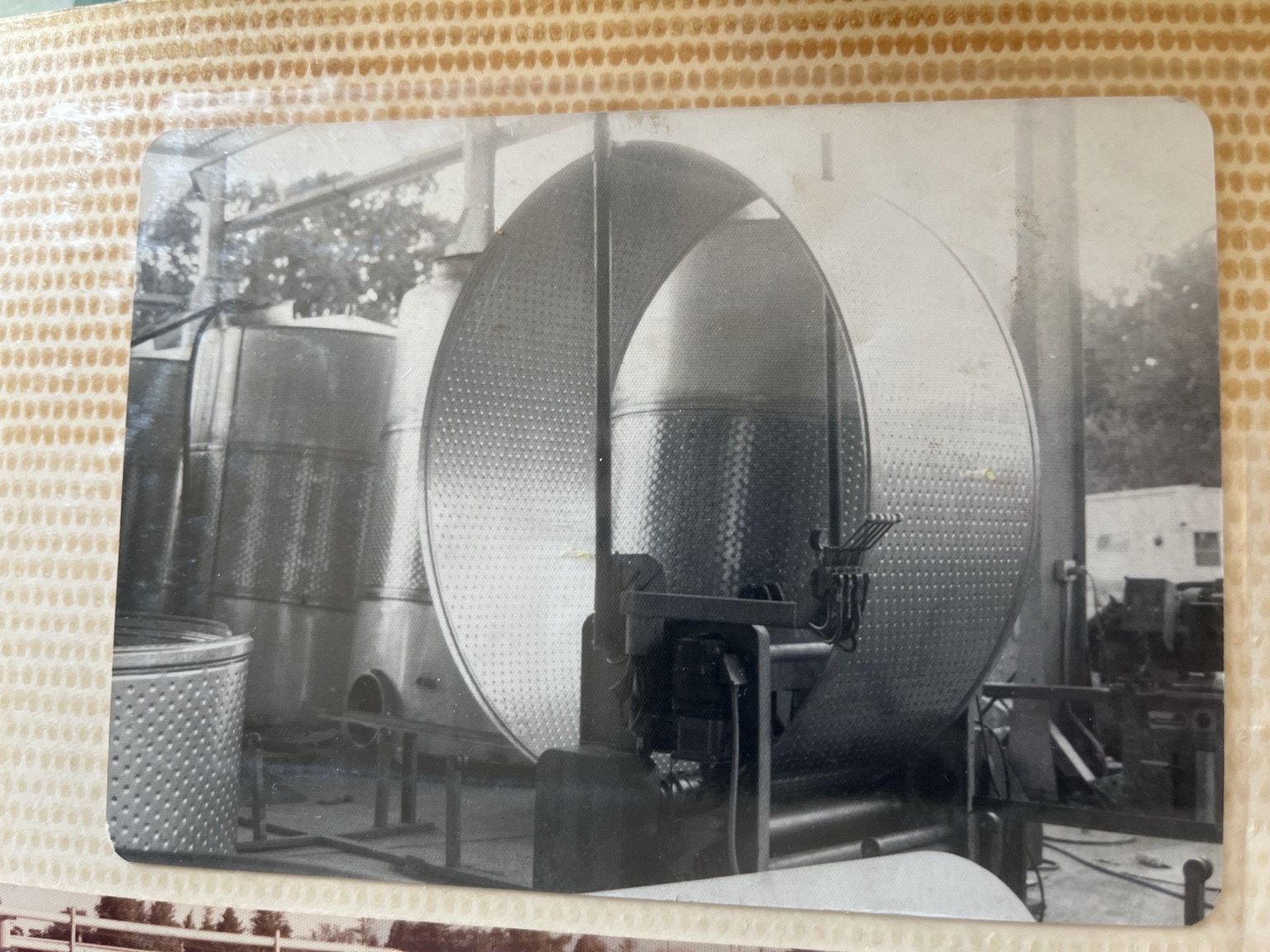 Historical photograph of large stainless-steel winery equipment