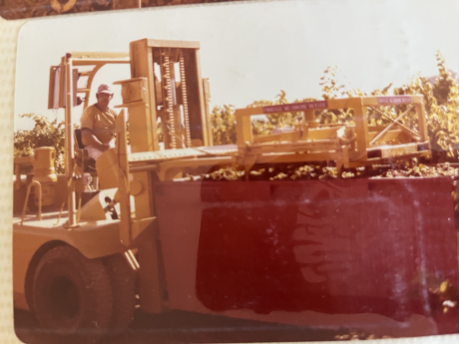 Historical photograph of a forklift carrying equipment marked Fragile Weighing Device
