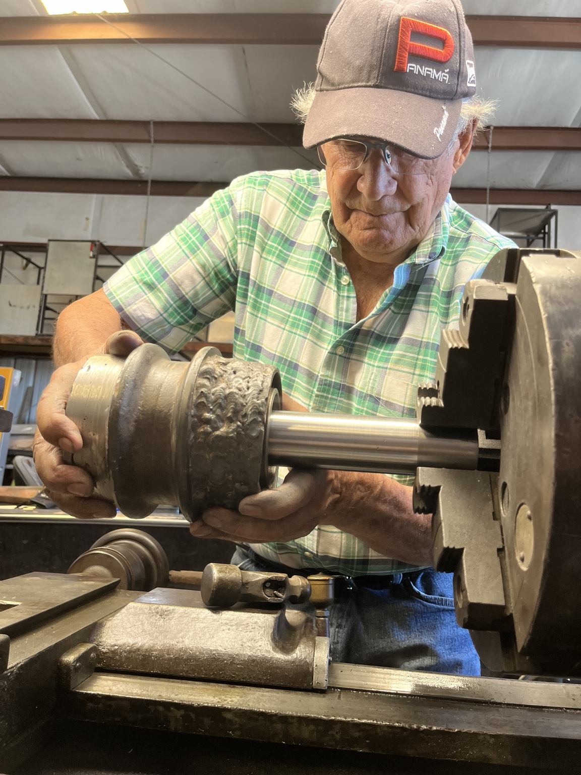 John K. Kalua working at a metal lathe